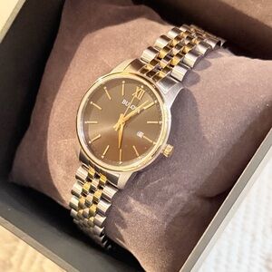 Womens Bulova Classic Wristwatch with a black face and a gold/silver band lk new